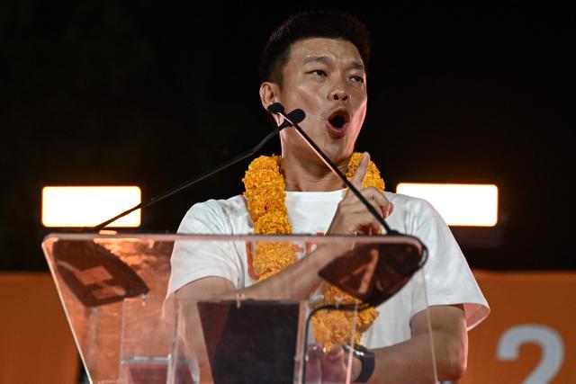 People's Party leader and prime ministerial candidate Natthaphong Ruengpanyawut addresses a rally ahead of the general election in Bangkok on January 25, 2026. (Photo by Lillian SUWANRUMPHA / AFP)