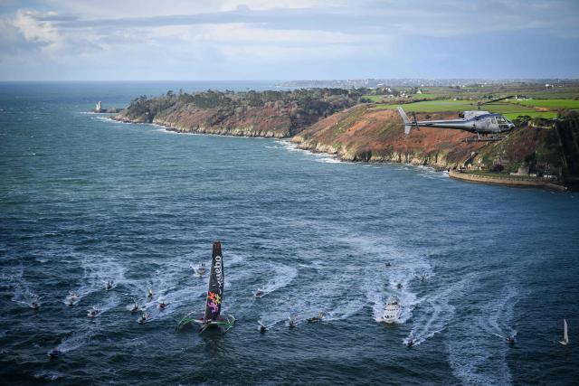 French skipper Thomas Coville and his crew members sail aboard the Ultim class multihull "Sodebo Ultim 3" after crossing the finish line at the end of their Jules Verne Trophy attempt, in the Atlantic Ocean, off the coast of Brest, Brittany, western France, on January 25, 2026. The Jules Verne Trophy is a prize for the fastest crewed, unassisted and non-stop circumnavigation of the world on any type of yacht. (Photo by Loic VENANCE / AFP)