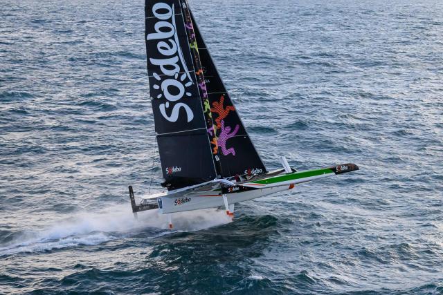French skipper Thomas Coville and his crew members sail aboard the Ultim class multihull "Sodebo Ultim 3" after crossing the finish line at the end of their Jules Verne Trophy attempt, in the Atlantic Ocean, off the coast of Brest, Brittany, western France, on January 25, 2026. Thomas Coville (Sodebo) and his six crew members completed a non-stop round-the-world voyage off the coast of Brest on January 25, 2026 in a record time of 40 days, 10 hours and 45 minutes, beating the previous Jules Verne Trophy record by 12 hours, his team announced. The Jules Verne Trophy is a prize for the fastest crewed, unassisted and non-stop circumnavigation of the world on any type of yacht. (Photo by Loic VENANCE / AFP)
