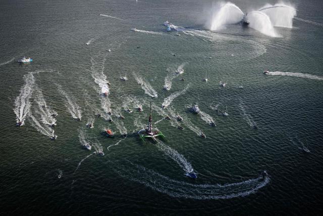 French skipper Thomas Coville and his crew members sail aboard the Ultim class multihull "Sodebo Ultim 3" after crossing the finish line at the end of their Jules Verne Trophy attempt, in the Atlantic Ocean, off the coast of Brest, Brittany, western France, on January 25, 2026. Thomas Coville (Sodebo) and his six crew members completed a non-stop round-the-world voyage off the coast of Brest on January 25, 2026 in a record time of 40 days, 10 hours and 45 minutes, beating the previous Jules Verne Trophy record by 12 hours, his team announced. The Jules Verne Trophy is a prize for the fastest crewed, unassisted and non-stop circumnavigation of the world on any type of yacht. (Photo by Loic VENANCE / AFP)