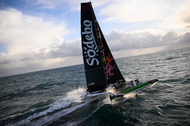 French skipper Thomas Coville and his crew members sail the Atlantic Ocean on the Ultim class multihull "Sodebo Ultim 3" after crossing the finish line of their successful attempt of breaking the Jules Verne Trophy record in 40 days 10 hours and 45 minutes, off the coast of Brest, Brittany, on January 25, 2026. The Jules Verne Trophy is a prize for the fastest crewed, unassisted and non-stop circumnavigation of the world on any type of yacht. (Photo by Loic VENANCE / AFP)