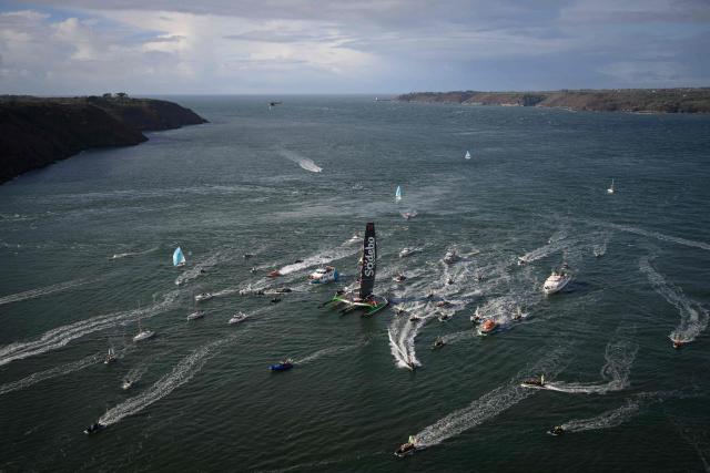 French skipper Thomas Coville and his crew members are welcome by boats as they approach Brest harbour on the Ultim class multihull "Sodebo Ultim 3" after crossing the finish line of their successful attempt of breaking the Jules Verne Trophy record in 40 days 10 hours and 45 minutes, off the coast of Brest, Brittany, on January 25, 2026. The Jules Verne Trophy is a prize for the fastest crewed, unassisted and non-stop circumnavigation of the world on any type of yacht. (Photo by Loic VENANCE / AFP)