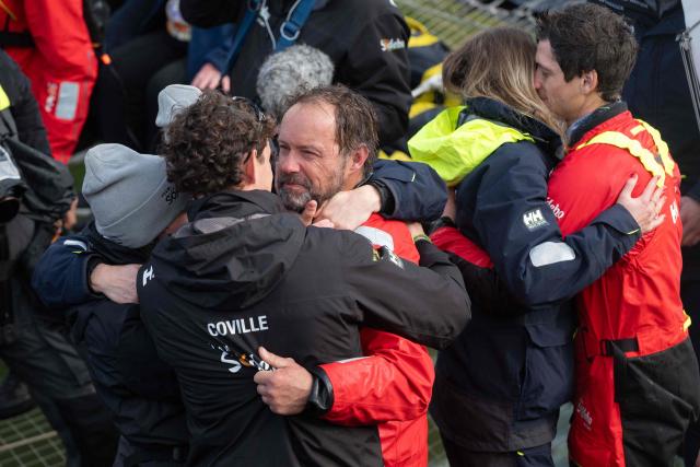 French skipper Thomas Coville celebrates with his wife and two children as he enters with his crew the Brest harbour on the Ultim class multihull "Sodebo Ultim 3" after crossing the finish line of their successful attempt of breaking the Jules Verne Trophy record in 40 days 10 hours and 45 minutes, off the coast of Brest, Brittany, on January 25, 2026. The Jules Verne Trophy is a prize for the fastest crewed, unassisted and non-stop circumnavigation of the world on any type of yacht. (Photo by Sebastien Salom-Gomis / AFP)