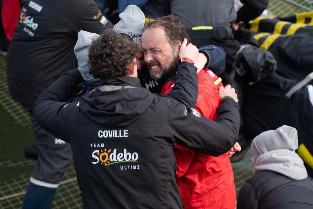 French skipper Thomas Coville celebrates with his wife and two children as he enters with his crew the Brest harbour on the Ultim class multihull "Sodebo Ultim 3" after crossing the finish line of their successful attempt of breaking the Jules Verne Trophy record in 40 days 10 hours and 45 minutes, off the coast of Brest, Brittany, on January 25, 2026. The Jules Verne Trophy is a prize for the fastest crewed, unassisted and non-stop circumnavigation of the world on any type of yacht. (Photo by Sebastien Salom-Gomis / AFP)