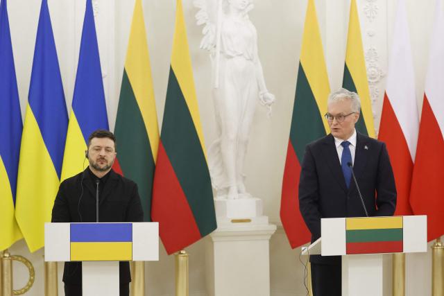 Lithuania's President Gitanas Nauseda (R) speaks during a joint press conference with Poland's President as Ukraine's President Volodymyr Zelensky (L) looks on after attending commemorations of the 1863 uprising, in Vilnius on January 25, 2026. (Photo by Petras Malukas / AFP)