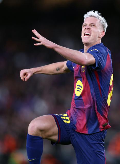Barcelona's Spanish midfielder #20 Daniel Olmo celebrates scoring the opening goal during the Spanish league football match between FC Barcelona and Real Oviedo at Camp Nou Stadium in Barcelona on January 25, 2026. (Photo by Josep LAGO / AFP)