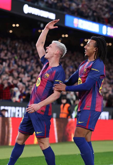 Barcelona's Spanish midfielder #20 Daniel Olmo (L) celebrates scoring the opening goal next to Barcelona's French defender #23 Jules Kounde during the Spanish league football match between FC Barcelona and Real Oviedo at Camp Nou Stadium in Barcelona on January 25, 2026. (Photo by Josep LAGO / AFP)