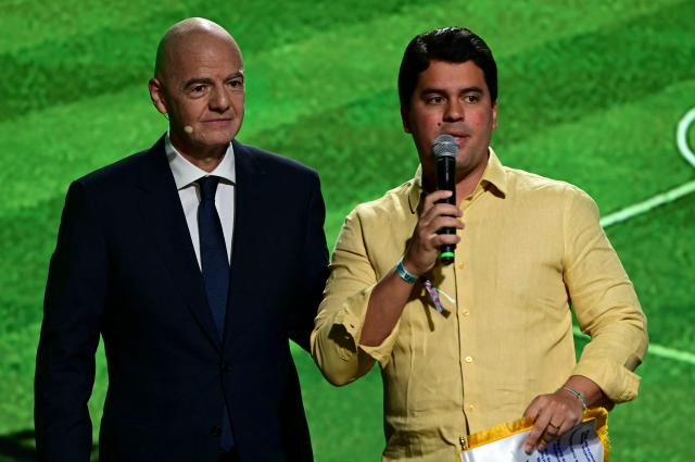 Brazil's Sports Minister Andre Fufuca (R) speaks while presenting FIFA President Gianni Infantino with a commemorative pennant during the 2027 FIFA Women's World Cup launch ceremony in Rio de Janeiro, Brazil on January 25, 2026. (Photo by Pablo PORCIUNCULA / AFP)