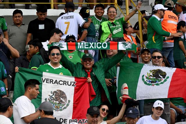 Mexican fans show national flags ahead of the international friendly football match between Bolivia and Mexico at the Ramon Aguilera Costa Stadium in Santa Cruz de la Sierra, Bolivia on January 25, 2026. (Photo by Aizar RALDES / AFP)