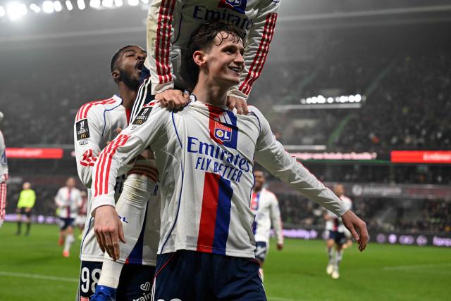 Lyon's English midfielder #23 Tyler Morton (C) celebrates with teammates after scoring Lyon's third goal during the French L1 football match between Metz and Olympique Lyonnais (OL) at the Stade Saint-Symphorien in Longeville-les-Metz, eastern France, on January 25, 2026. (Photo by Jean-Christophe VERHAEGEN / AFP)