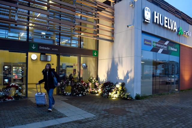 Floral wreaths are seen at the entrance of the Huelva railway station where a vigil in honour of the victims of the January 18 high-speed train accident that killed 45 people in Adamuz, was held on January 25, 2026, in Huelva. One week after the train disaster involving two trains in southern Spain, which left 45 dead, remembrance ceremonies took place today in Huelva, where most of the victims came from, and in the town of Adamuz, where the collision occurred. (Photo by CRISTINA QUICLER / AFP)