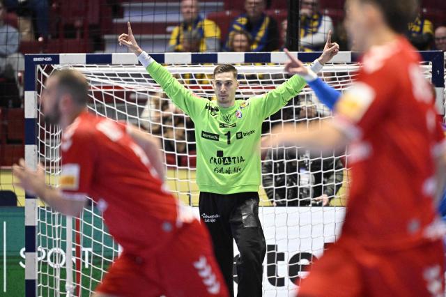 Croatia's goalkeeper #01 Dominik Kuzmanovic (C) gestures during the men's EHF Euro 2026 main round handball match Switzerland v Croatia in Malmo, Sweden, on January 25, 2026. (Photo by Johan Nilsson/TT / TT NEWS AGENCY / AFP) / Sweden OUT