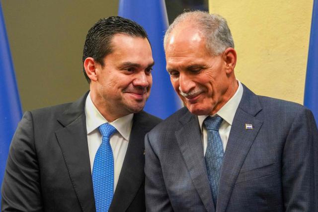 Honduran President-elect Nasry Asfura gestures next to Tegucigalpa's Mayor Juan Diego Zelaya during the inauguration of the National Mayor's Office of the Central District at the National Museum in Tegucigalpa on January 25, 2026. Earliert this month Honduras electoral authorities rejected an order by the outgoing president to recount November's election won by Trump-backed candidate Nasry Asfura, a conservative businessman who was declared the winner of Honduras's presidential election on December 24, weeks after a tight race marred by delays and allegations of fraud. (Photo by Johny MAGALLANES / AFP)