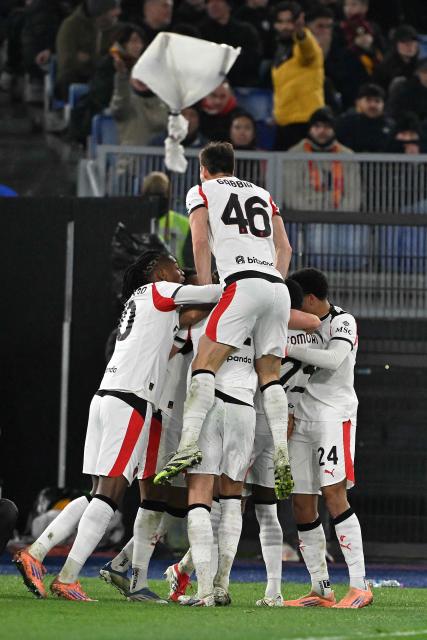 AC Milan's Belgian defender #05 Koni De Winter (C unseen) celebrates with teammates after scoring AC Milan's first goal during the Italian Serie A football match between AS Roma and AC Milan at the Olympic Stadium in Rome on January 25, 2026. (Photo by Andreas SOLARO / AFP)