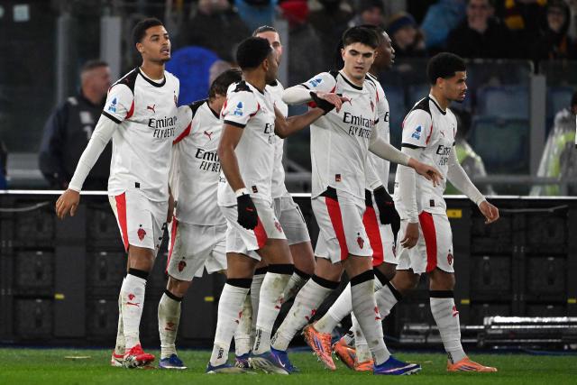 AC Milan's Belgian defender #05 Koni De Winter (L) celebrates with teammates after scoring AC Milan's first goal during the Italian Serie A football match between AS Roma and AC Milan at the Olympic Stadium in Rome on January 25, 2026. (Photo by Andreas SOLARO / AFP)