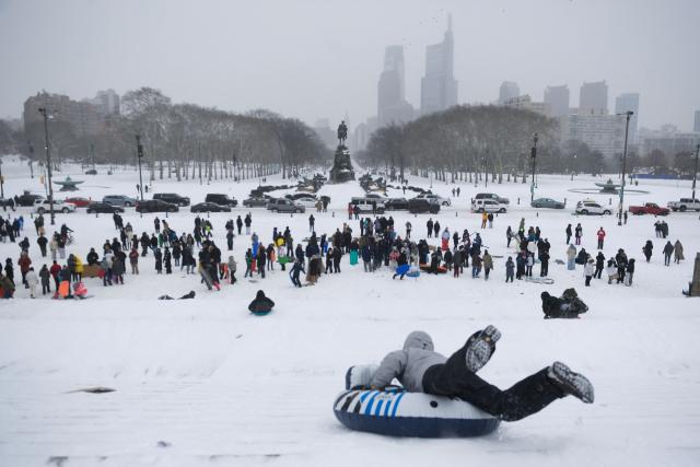 Philadelphia residents gather and sled down the steps of the Philadelphia Art Museum during a heavy snowfall in Philadelphia, Pennsylvania, on January 25, 2026. A massive winter storm headed towards the northeast United States after sweeping across much of the country, threatening tens of millions of Americans with blackouts, transportation chaos and bone-chilling cold. After battering the country's southwest and central areas, the storm system began to hit the heavily populated mid-Atlantic and northeastern states with snow and freezing rain as a frigid air mass settled in across the nation. (Photo by Matthew HATCHER / AFP)