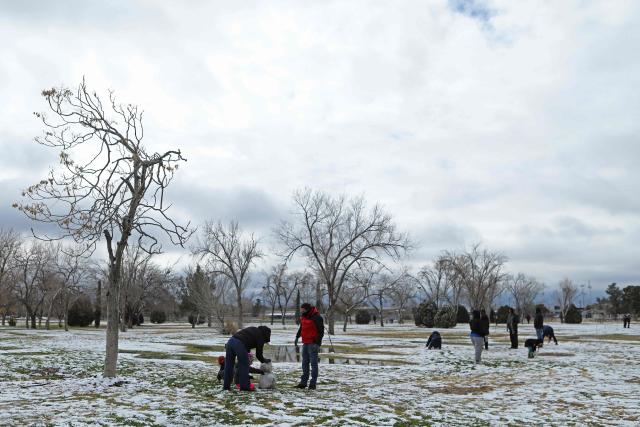People play in the snow at El Chamizal Park in Ciudad Juarez, Chihuahua State, Mexico on January 25, 2026. (Photo by Herika MARTINEZ / AFP)