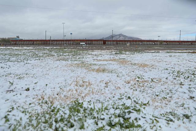Snow covers the ground near the border wall with United States in Ciudad Juarez, Chihuahua State, Mexico on January 25, 2026. (Photo by Herika MARTINEZ / AFP)