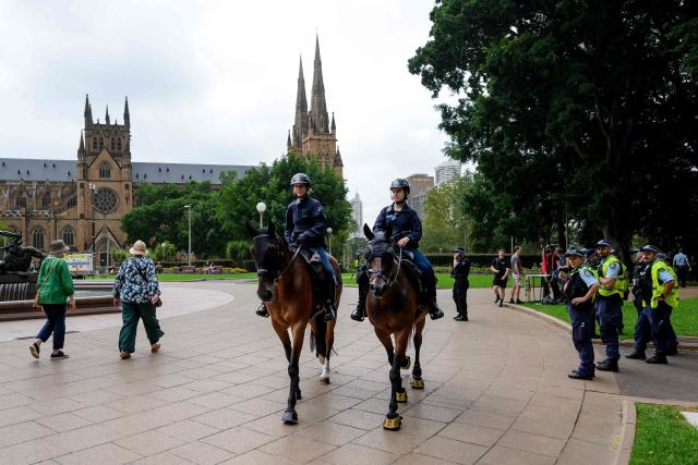 Mounted police officers patrol as protesters gather for the annual "Invasion Day" rally, organised on Australia Day, in Sydney on January 26, 2026. (Photo by Steven Markham / AFP)