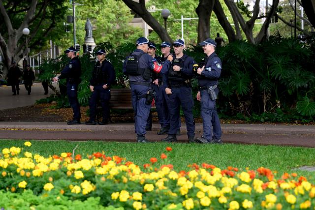Police officers are seen as protesters gather for the annual "Invasion Day" rally, organised on Australia Day, in Sydney on January 26, 2026. (Photo by Steven Markham / AFP)
