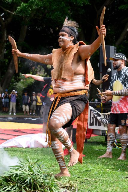 A protester takes part in an Australian aboriginal smoking ceremony during the annual "Invasion Day" rally, organised on Australia Day, in Sydney on January 26, 2026. (Photo by Steven Markham / AFP)