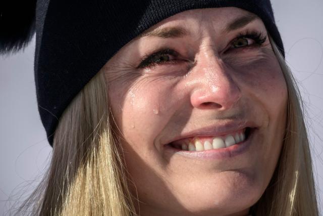 (FILES) First-placed US Lindsey Vonn cries on the podium as she celebrates after competing in the women's downhill race during the FIS Alpine Ski World Cup 2025-2026, in St Moritz, south-eastern Switzerland on December 12, 2025. US ski star Lindsey Vonn has defied age and injury to make one of the most remarkable comebacks in Olympic history, the latest chapter in a storied career of memorable highs and crushing setbacks. Vonn will be 41 when she takes to the slope of Cortina d'Ampezzo next month for her fifth Olympics. She retired after the 2019 world championships in Are but made what she dubbed a "crazy" comeback last winter. (Photo by Fabrice COFFRINI / AFP)