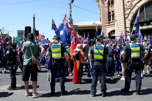 Police watch as demonstrators gather to take part in the annual "Invasion Day" protest march through the streets of Melbourne on Australia Day on January 26, 2026. (Photo by Izhar KHAN / AFP)