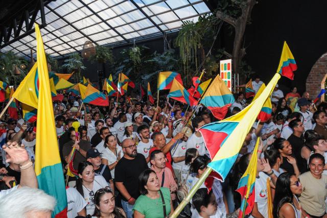 Supporters of Costa Rica's presidential candidate of the Citizen Agenda Coalition and former first lady, Claudia Dobles, wave flags during her closing campaign rally at the Mercadito La California in San Jose on January 25, 2026. Right-wing politician Laura Fernandez appears set to win Costa Rica's presidential election in the first round, according to two opinion polls published on January 21. (Photo by Marvin CARAVACA / AFP)