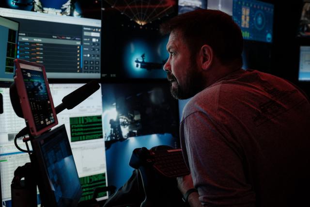 This photo taken on January 10, 2026 shows the crew of the OceanXplorer, a research vessel operated by the marine non-profit OceanX, operating a remotely operated vehicle (ROV) from a control room in the waters off Sulawesi island. A dome-fronted submersible sinks beneath the waves off Indonesia, heading nearly 1,000 metres down to the realm of purple-frilled corals and bioluminescent shrimp. This month, AFP boarded one of two submersibles belonging to OceanX, a non-profit founded by billionaire Ray Dalio and his son that works with scientists on its OceanXplorer ship to study the marine world. (Photo by YASUYOSHI CHIBA / AFP) / To go with 'INDONESIA-OCEANX-OCEANS-ENVIRONMENT-RESEARCH-SCIENCE' by Sara HUSSEIN