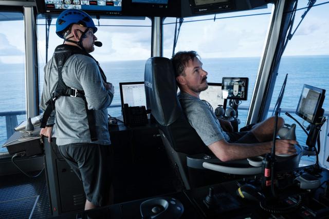 This photo taken on January 9, 2026 shows the crew of the OceanXplorer, a research vessel operated by the marine non-profit OceanX, navigating the vessel from the bridge in the waters off Sulawesi island, Indonesia. A dome-fronted submersible sinks beneath the waves off Indonesia, heading nearly 1,000 metres down to the realm of purple-frilled corals and bioluminescent shrimp. This month, AFP boarded one of two submersibles belonging to OceanX, a non-profit founded by billionaire Ray Dalio and his son that works with scientists on its OceanXplorer ship to study the marine world. (Photo by YASUYOSHI CHIBA / AFP) / To go with 'INDONESIA-OCEANX-OCEANS-ENVIRONMENT-RESEARCH-SCIENCE' by Sara HUSSEIN
