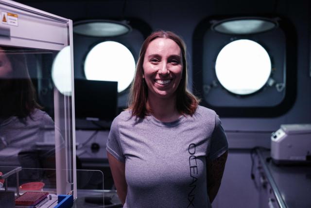 This photo taken on January 11, 2026, shows Larissa Fruehe, a German environmental DNA (eDNA) scientist, posing in her laboratory on the OceanXplorer, a research vessel operated by the marine non-profit OceanX, in waters off Sulawesi island. A dome-fronted submersible sinks beneath the waves off Indonesia, heading nearly 1,000 metres down to the realm of purple-frilled corals and bioluminescent shrimp. This month, AFP boarded one of two submersibles belonging to OceanX, a non-profit founded by billionaire Ray Dalio and his son that works with scientists on its OceanXplorer ship to study the marine world. (Photo by YASUYOSHI CHIBA / AFP) / To go with: INDONESIA-OCEANX-OCEANS-ENVIRONMENT-RESEARCH-SCIENCE, by Sara HUSSEIN