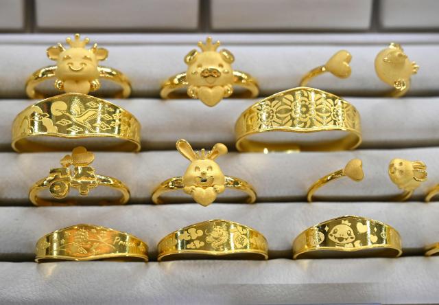 Gold jewelry is displayed at a store of the Korea Gold Exchange in Seoul on January 26, 2026. The price of safe-haven asset gold surpassed $5,000 on January 25, hitting a record amid rising global uncertainty and turmoil set off by US President Donald Trump's policies. (Photo by Jung Yeon-je / AFP)