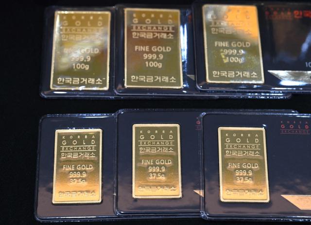 Gold bars are displayed at a store of the Korea Gold Exchange in Seoul on January 26, 2026. The price of safe-haven asset gold surpassed $5,000 on January 25, hitting a record amid rising global uncertainty and turmoil set off by US President Donald Trump's policies. (Photo by Jung Yeon-je / AFP)