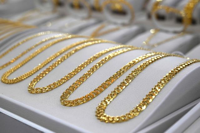 Gold jewelry is displayed at a store of the Korea Gold Exchange in Seoul on January 26, 2026. The price of safe-haven asset gold surpassed $5,000 on January 25, hitting a record amid rising global uncertainty and turmoil set off by US President Donald Trump's policies. (Photo by Jung Yeon-je / AFP)