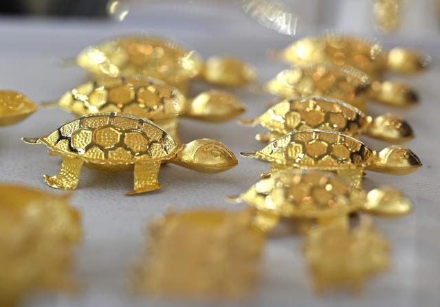 Gold jewelry is displayed at a store of the Korea Gold Exchange in Seoul on January 26, 2026. The price of safe-haven asset gold surpassed $5,000 on January 25, hitting a record amid rising global uncertainty and turmoil set off by US President Donald Trump's policies. (Photo by Jung Yeon-je / AFP)