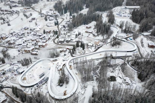 (FILES) This aerial view shows the Olympic sliding center venue hosting the luge and bobsleigh competitions in Cortina, northern Italy, ahead of the Milano Cortina 2026 Olympic Games, on January 24, 2026. (Photo by Odd ANDERSEN / AFP)