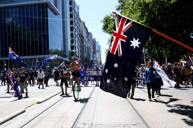 Anti-government protesters march along a road during a protest on Australia Day in Melbourne on January 26, 2026. (Photo by Izhar KHAN / AFP)
