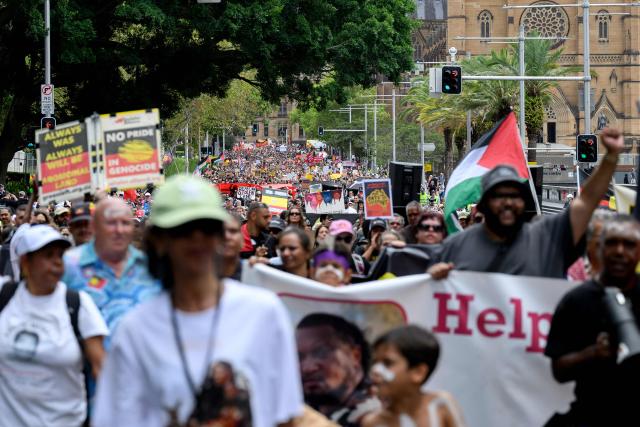 Protesters take part in the annual "Invasion Day" rally, organised on Australia Day, in Sydney on January 26, 2026. (Photo by Steven Markham / AFP)
