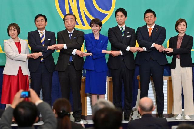 (L-R) Japanese Communist Party Chair Tomoko Tamura, Democratic Party for the People leader Yuichiro Tamaki, Centrist Reform Alliance co-leader Yoshihiko Noda, Liberal Democratic Party President and Prime Minister Sanae Takaichi, Japan Innovation Party co-leader Fumitake Fujita, Sanseito leader Sohei Kamiya, Reiwa Shinsengumi co-leader Akiko Oishi pose during a panel discussion at the Japan National Press Club (JNPC) in Tokyo on January 26, 2026. (Photo by David Mareuil / POOL / AFP)