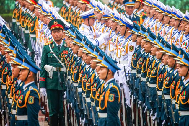 Members of the guard of honor prepare ahead a welcoming ceremony at the presidential palace in Hanoi on January 26, 2026. (Photo by LUONG THAI LINH / POOL / AFP)