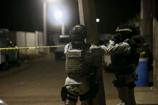 Members of the National Guard install a yellow police line at the crime scene where at least 11 people were killed and 12 more wounded in Salamanca, Guanajuato state, Mexico, on January 25, 2026. The attack occurred in a neighborhood in the town of Salamanca, with a statement from the mayor's office saying that officials launched an operation to find those responsible for the assault. (Photo by Mario Armas / AFP)