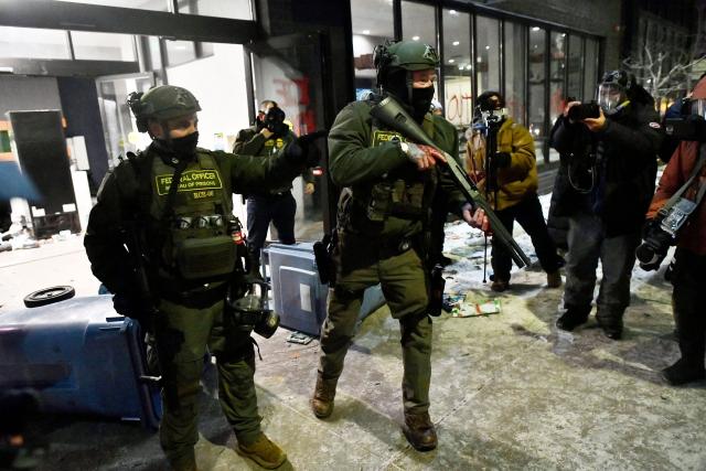 Federal agents push back protesters during the "ICE OUT! Noise Demo" outside a hotel in Minneapolis, Minnesota on January 25, 2026. On January 24, federal agents shot dead US citizen Alex Pretti, a 37-year-old ICU nurse, while scuffling with him on an icy roadway, less than three weeks after an immigration officer shot and killed Renee Good, also 37, in her car.
His killing sparked new protests and impassioned demands by local leaders for the Trump administration to end its operation in the city. (Photo by Octavio JONES / AFP)