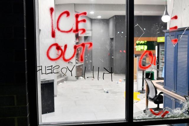 Graffitis and a shattered glass window are seen while protesters participate in the "ICE OUT! Noise Demo" at a hotel in Minneapolis, Minnesota on January 25, 2026. On January 24, federal agents shot dead US citizen Alex Pretti, a 37-year-old ICU nurse, while scuffling with him on an icy roadway, less than three weeks after an immigration officer shot and killed Renee Good, also 37, in her car.
His killing sparked new protests and impassioned demands by local leaders for the Trump administration to end its operation in the city. (Photo by Octavio JONES / AFP)