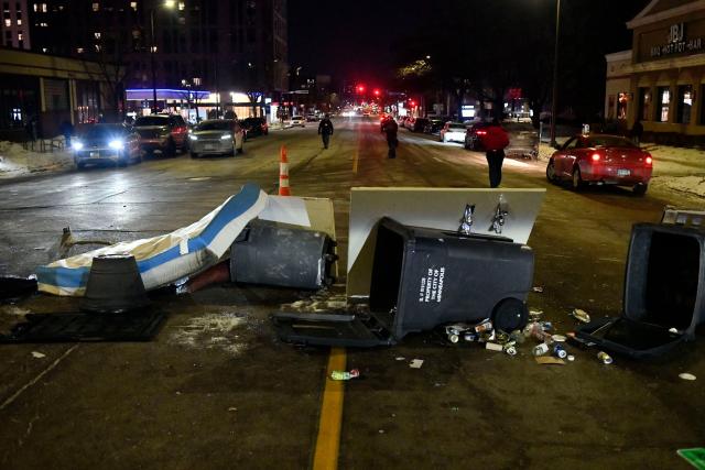 Trash cans, left by anti-ICE protesters, block a street outside a hotel during the "ICE OUT! Noise Demo" in Minneapolis, Minnesota on January 25, 2026. On January 24, federal agents shot dead US citizen Alex Pretti, a 37-year-old ICU nurse, while scuffling with him on an icy roadway, less than three weeks after an immigration officer shot and killed Renee Good, also 37, in her car.
His killing sparked new protests and impassioned demands by local leaders for the Trump administration to end its operation in the city. (Photo by Octavio JONES / AFP)