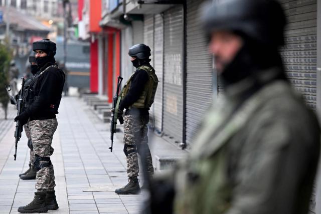 Indian paramilitary troopers stand guard along a street during India's 77th Republic Day celebrations in Srinagar on January 26, 2026. (Photo by Tauseef MUSTAFA / AFP)