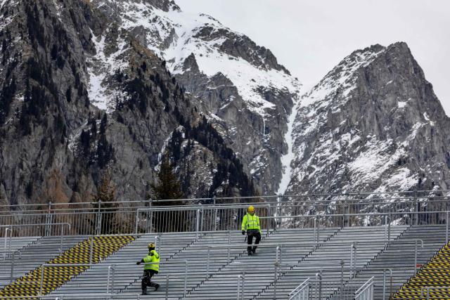 (FILES) Construction workers inspect the main stand at the Biathlon venue in Antholz, northern Italy, prior to the Milano Cortina 2026 Olympic Games, on January 23, 2026. (Photo by Odd ANDERSEN / AFP)