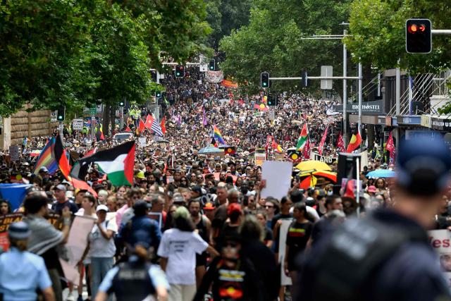 Demonstrators take part in the annual "Invasion Day" rally through the streets of Sydney on Australia Day on January 26, 2026. Tens of thousands of Australians protested over the treatment of Indigenous people as they rallied on a contentious national holiday that also marks the arrival of European colonists more than 200 years ago. (Photo by Steven Markham / AFP)