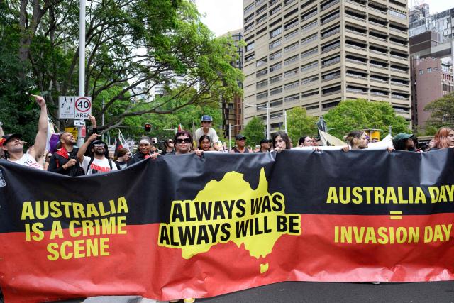Demonstrators take part in the annual "Invasion Day" rally through the streets of Sydney on Australia Day on January 26, 2026. Tens of thousands of Australians protested over the treatment of Indigenous people as they rallied on a contentious national holiday that also marks the arrival of European colonists more than 200 years ago. (Photo by Steven Markham / AFP)