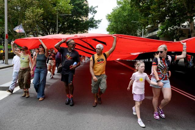 Demonstrators take part in the annual "Invasion Day" rally through the streets of Sydney on Australia Day on January 26, 2026. Tens of thousands of Australians protested over the treatment of Indigenous people as they rallied on a contentious national holiday that also marks the arrival of European colonists more than 200 years ago. (Photo by Steven Markham / AFP)
