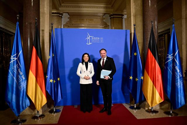 German Economy and Energy Minister Katherina Reiche welcomes EU Commissioner for Energy and Housing Dan Jorgensen as he arrives to attend the North Sea Summit on January 26, 2026 in Hamburg, northern Germany. European leaders meet to discuss North Sea energy and security cooperation, but fears over US designs on the Arctic island of Greenland may overshadow the talks. The region has long worried about threats posed by Russia -- but more recently tensions have surged over US President Donald Trump's push for the autonomous territory of Denmark. (Photo by Tobias SCHWARZ / AFP)